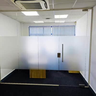 Glass Partitions fitted into white RAL 9010 aluminium frames.
