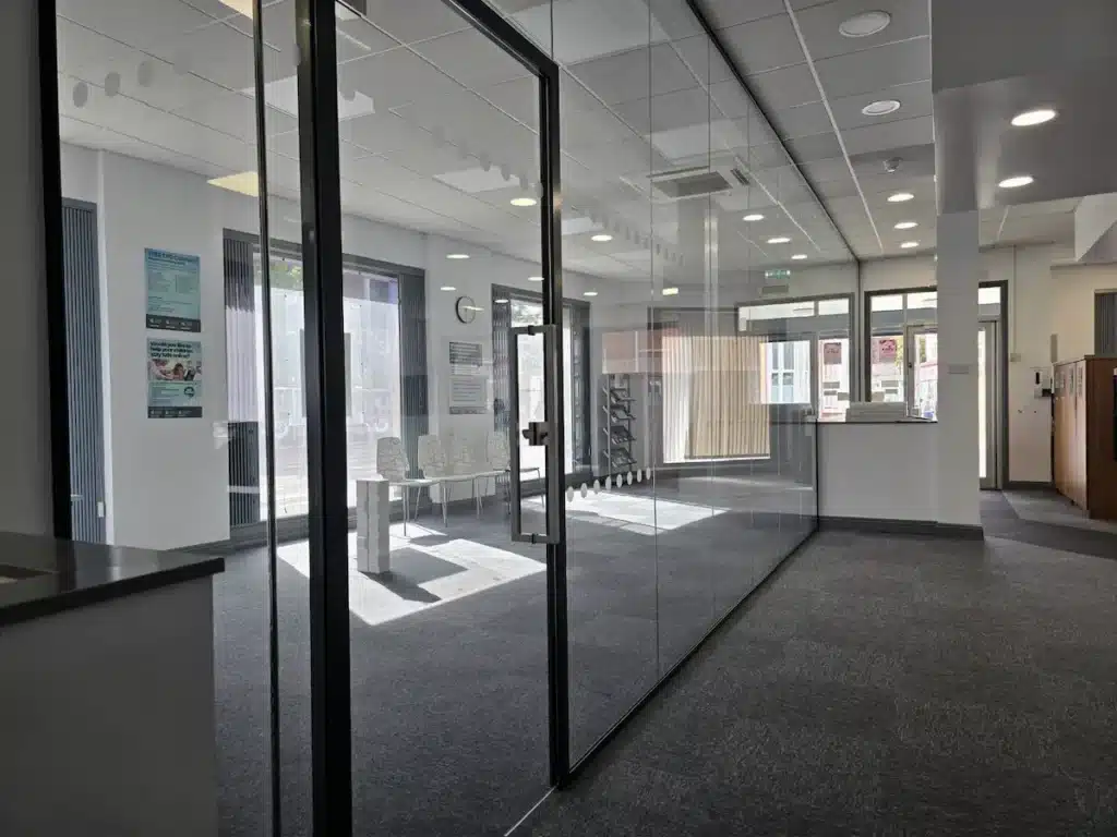 Framed Glass Door withing the Long Glass Partition Wall