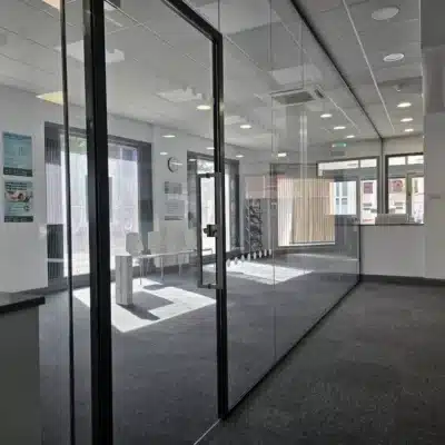 Framed Glass Door withing the Long Glass Partition Wall