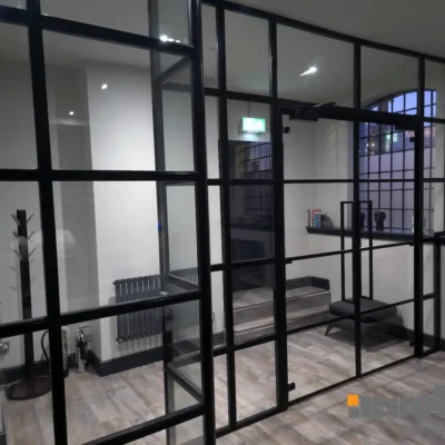 Black-framed glass office partition with door in Birmingham period building