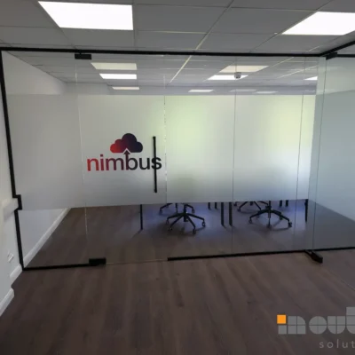 Frosted glazed partition wall with Nimbus branding installed in a Nottingham office meeting room