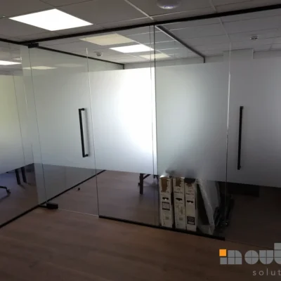 Corner glazed partition combining clear and frosted glass panels in a Nottingham office