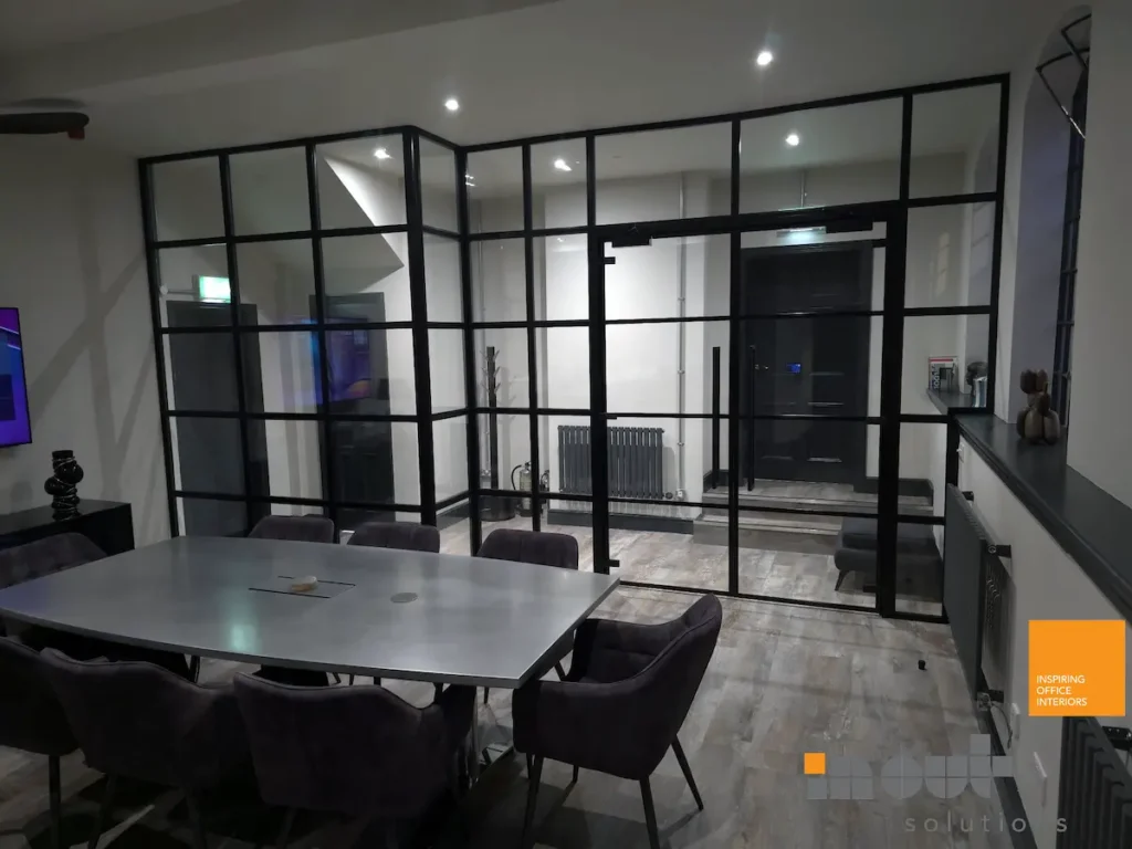Black-framed glass partition around a corner meeting room in Birmingham office