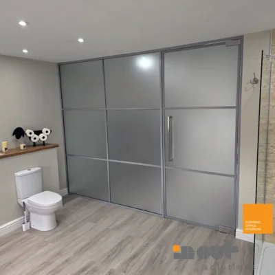 Frosted sliding glass room divider separating a bathroom from an adjoining bedroom in Yorkshire