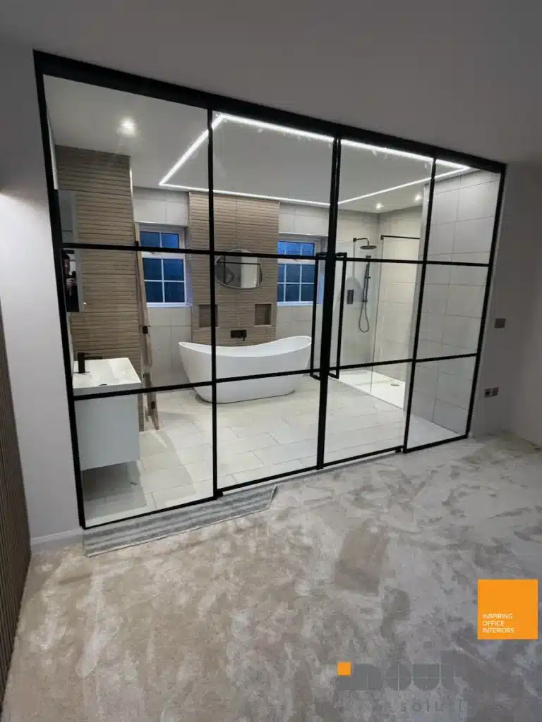 Black-framed glass room divider separating a bedroom from an ensuite bathroom in Hull, Yorkshire